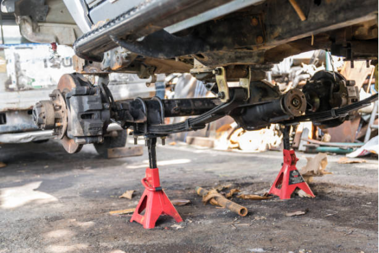 mechanic using multi-point Jack Stand setup for stable maintenance