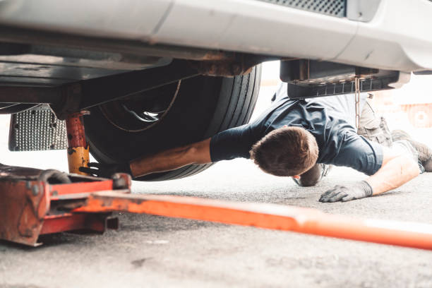 Mechanic uses jack and jack stands to support vehicle.